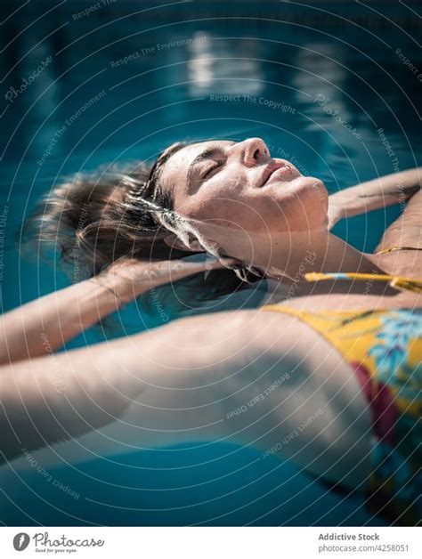Relaxed Woman Floating In Warm Pool Water A Royalty Free Stock Photo From Photocase