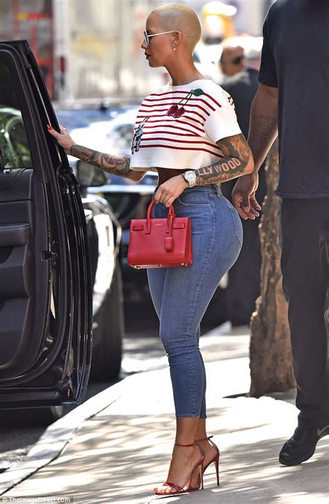 Amber Rose Flaunts Curves In Crop Top And Painted On Jeans Daily Mail