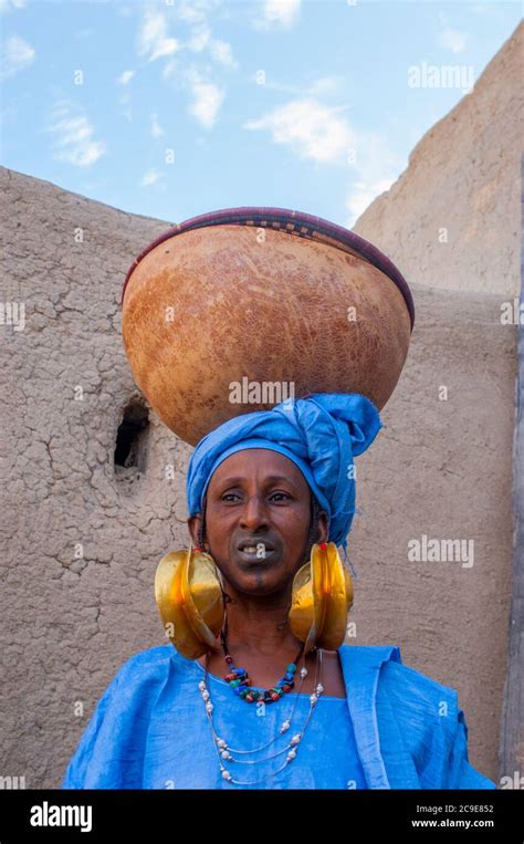 A Fulani Tribal Woman With Festive Gold Earrings And Tattooed Lips