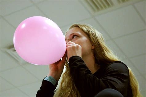 blowing up a balloon 2c senior jenna keiser helps her fellow srt seniors do something for mr