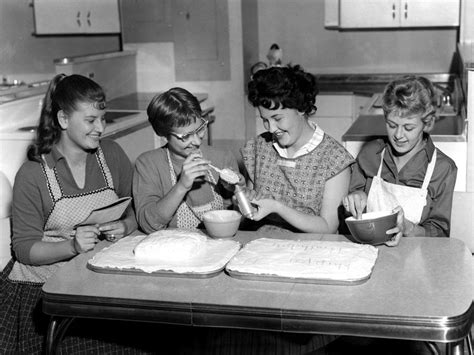 Girls Decorating Cake In Home Economics Class Photograph By Mark Goebel