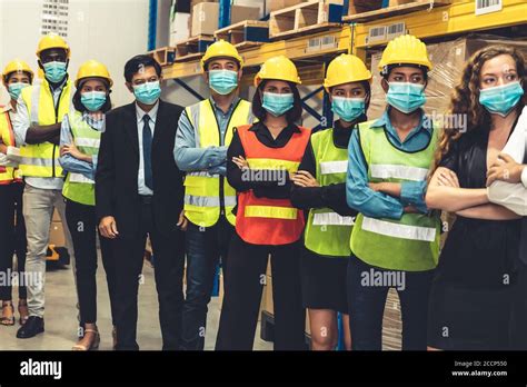 Group Of Factory Industry Workers Working With Face Mask To Prevent