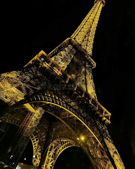 Under The Eiffel Tower Illuminated At Night Editorial Photography