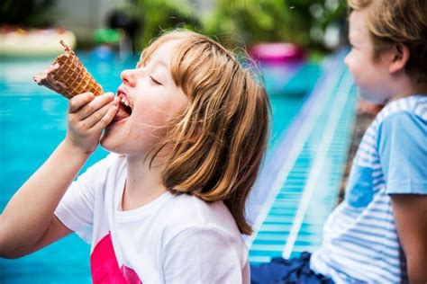 Free Photo Closeup Of Caucasian Girl Eating Ice Cream By The Pool
