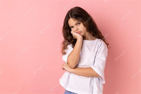 Premium Photo Bored Little Girl Leaning On Hand And Looking Depressed