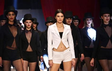 Models Walk Down The Runway In Short Shorts And Tuxedo Outfits With Hats On Their Heads