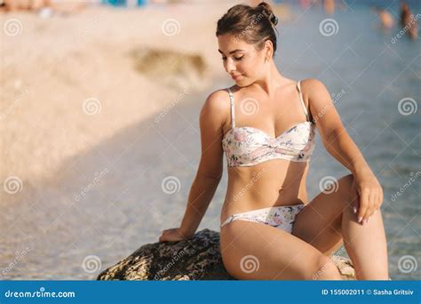 Beautiful Woman In Bikini Sit On The Stone In Front Of Sea Stock Image Image Of Ocean Beach