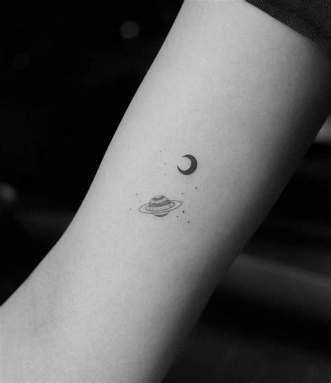 Small Single Needle Crescent And Saturn Tattoo On The Inner Arm