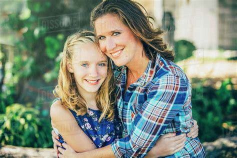 Caucasian Mother And Daughter Hugging Outdoors Stock Photo Dissolve