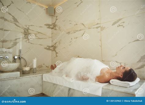 Peaceful Woman Covered With Soap Foam Relaxing In Turkish Bath Stock