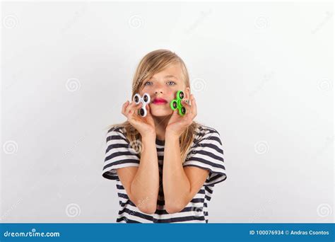 Girl Playing With Two Fidget Spinners Stock Photo Image Of Spinners Green