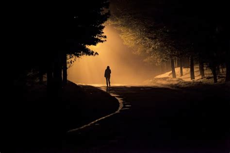 Premium Photo Woman Walking Alone Into The Misty Foggy Road In A Dramatic Mystic Scene With