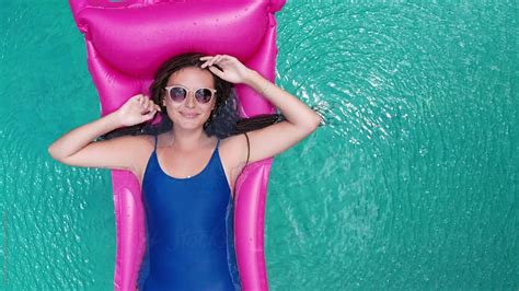 Beautiful Young Woman With Pink Air Mattress In Swimming Pool By Nikita