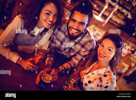 Portrait Of Young Friends Having Drinks Stock Photo Alamy