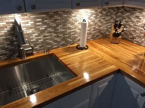 That beats the cost of most other popular options, including stainless steel ($20 to $150), glass ($25 to $100 per square foot), concrete ($25 to $75 per square foot), marble ($25 to $75 per square foot). gray-mosaic-tile-backsplash-butcher-block-countertops-whit ...