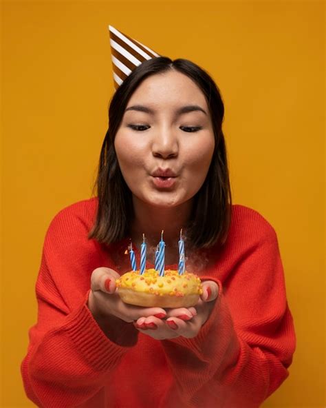 Free Photo Portrait Of A Teenage Girl Blowing The Birthday Candles