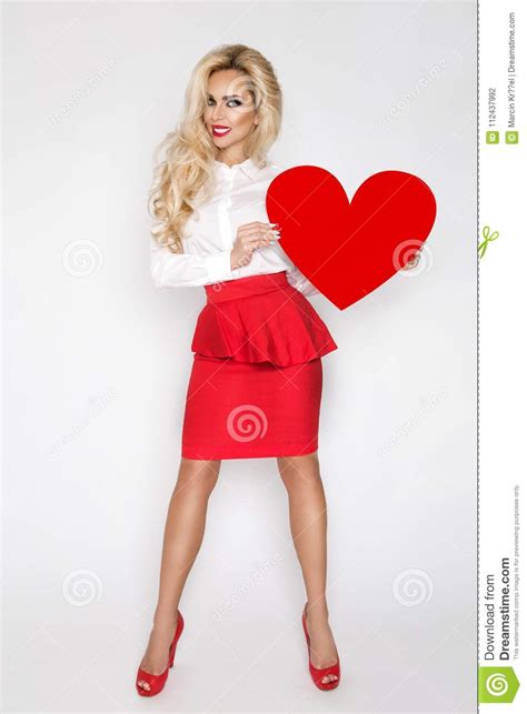 Beautiful Sexy Elegant Blonde Woman Holding A Red Valentine Heart