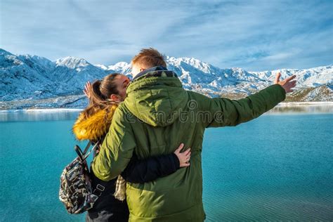 Happy Young Couple On The Background Of Snowy Mountains Stock Photo