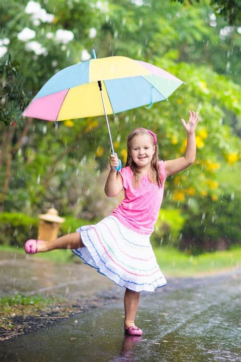 Kid With Umbrella Playing In Summer Rain Stock Photo Image Of Rainy