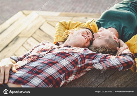 Happy Gay Couple Lying On A Bench Looking Each Other Young Lesbian Women Having A Tender