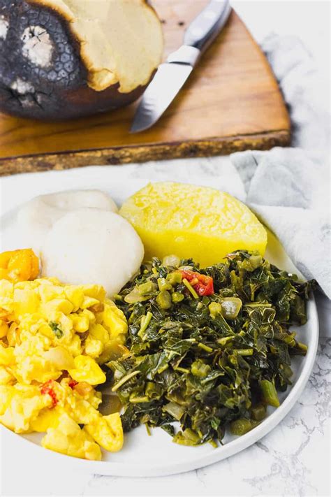 Jamaican Callaloo On White Plate With Ackee Yellow Yam Dumplings And