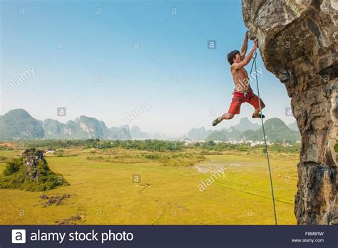 Male Climber Hanging From The Egg A Lime Stone Cliff In Yangshuo