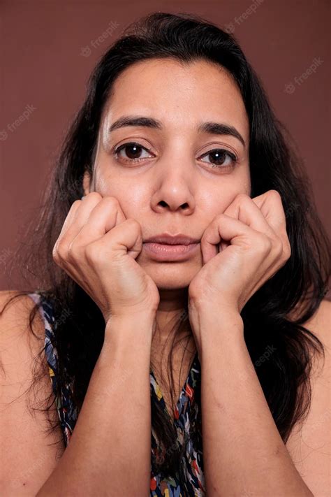 Premium Photo Indian Woman Holding Clenched Fists On Cheeks Closeup