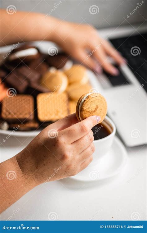 Mujer Snacking Con Los Dulces Y La Comida Basura Foto De Archivo