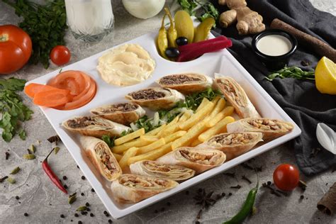 Thinly sliced meat, wrapped in a pita bread with veggies and sauce is a delicious quick meal. Arabic Shawarma Double (Chicken + Meat) / Meal - Laffah ...