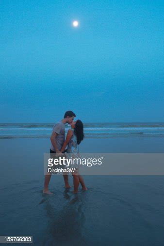 Couple Of Lovers On The Beach Under The Moonlight Photo Getty Images