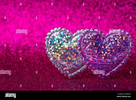 Two Glitter Hearts On Pink Sparkle Glitter Background San Valentine
