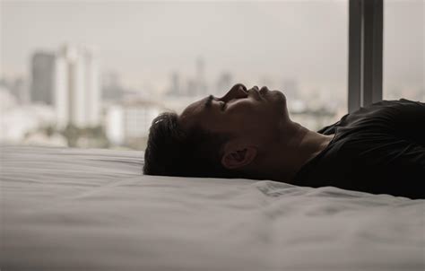 Asian Man Feels Sad Alone On Bed With City Background Stay Home Depression And Loneliness