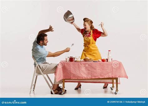 Portrait Of Young Emotive Couple Loudly Aggressively Quarreling While Doing Breakfast Isolated