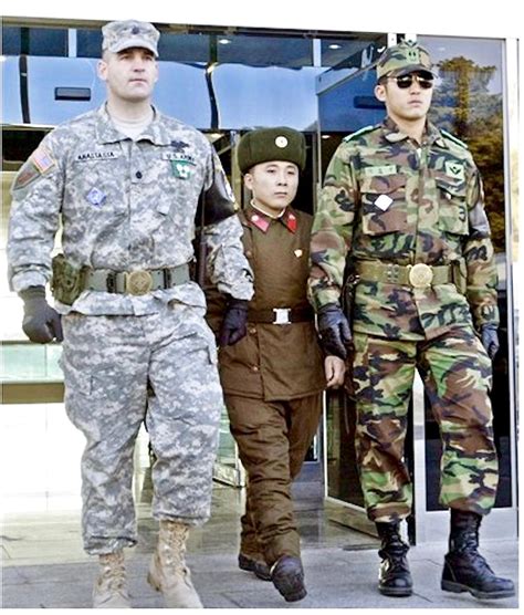 North Korean Dprk Soldier Walking In Between An American 1st Infantry Division And South