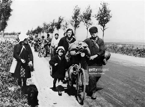 A Group Of Refugees Fleeing Upon The Arrival Of German Troops On The