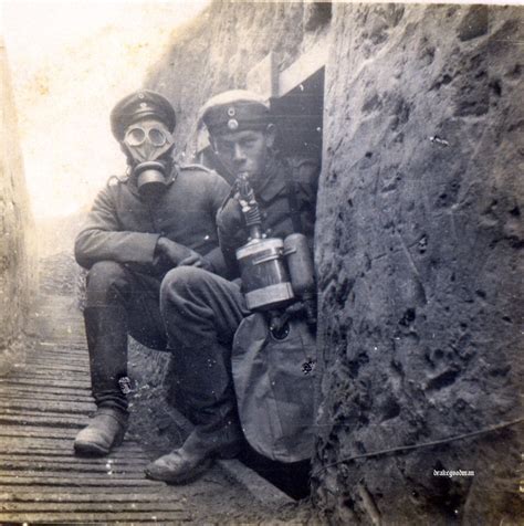 German Soldiers In A Trench One Wearing A Gas Mask And The Other A