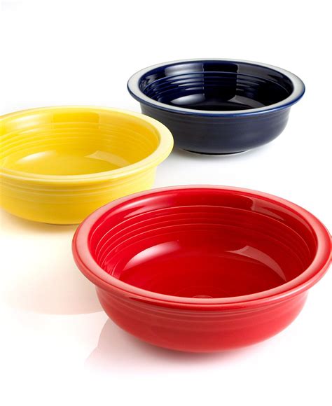three different colored bowls sitting next to each other