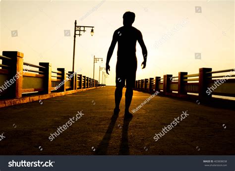 Silhouette Man Walking Sunset Stock Photo 403808038 Shutterstock