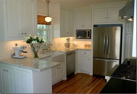 Wood cabinets are heavy duty, durable and can fit into any style. simple... white cabinets, light countertop, wood floors ...
