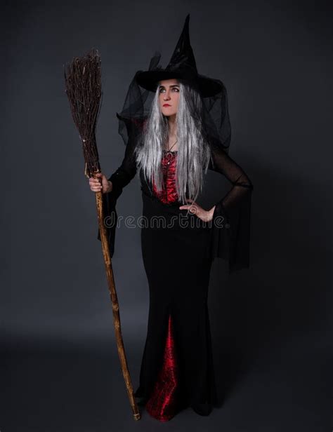 Full Length Portrait Of Mysterious Woman In Witch Halloween Costume