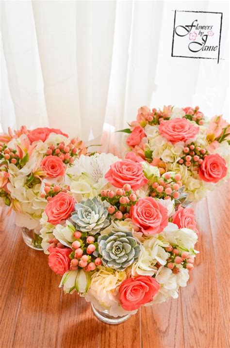 Can be ordered as bouquets, arrangements and or centerpieces. Calgary Bridal Bouquet of white hydrangea, coral roses ...