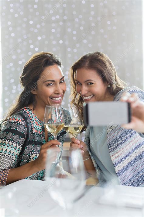 women with white wine taking selfie in restaurant stock image f015 2918 science photo library