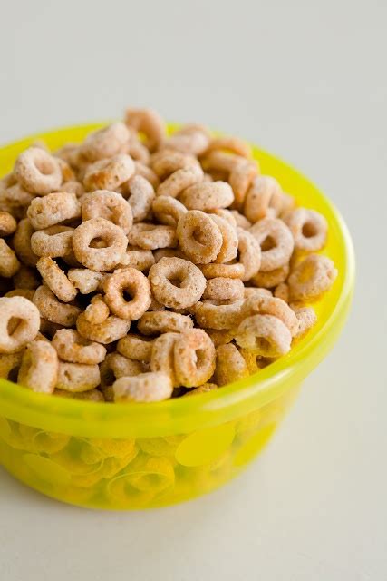 A Yellow Bowl Filled With Cereal Sitting On Top Of A Table