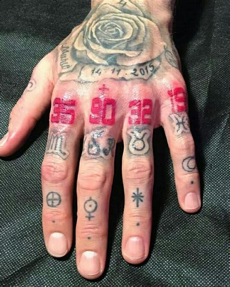 A Man With Tattoos On His Hands And Hand Is Covered In Red Ink That