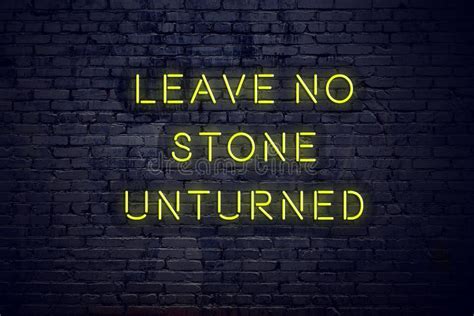 positive inspiring quote on neon sign against brick wall leave no stone unturned stock