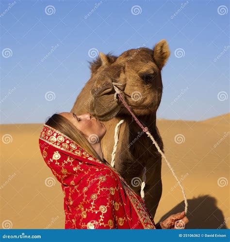 Woman Kissing Her Camel In The Desert Stock Photography Image 25106362