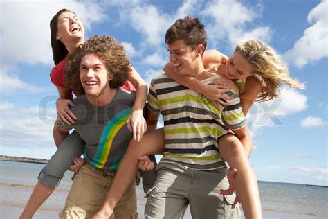 Group Of Young Friends Having Fun On Summer Beach Together Stock Image Colourbox