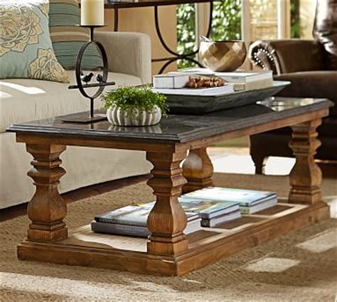Heavy wrought iron forms a linear base that looks warm against natural wood. Sutton Coffee Table | Pottery Barn
