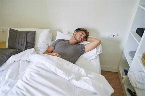 Man Sleeping On Bed In Bedroom At Home Stock Photo