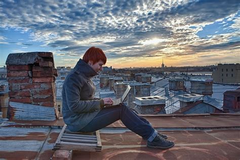 Premium Photo Redhead Girl Sits On The Roof Working With Laptop